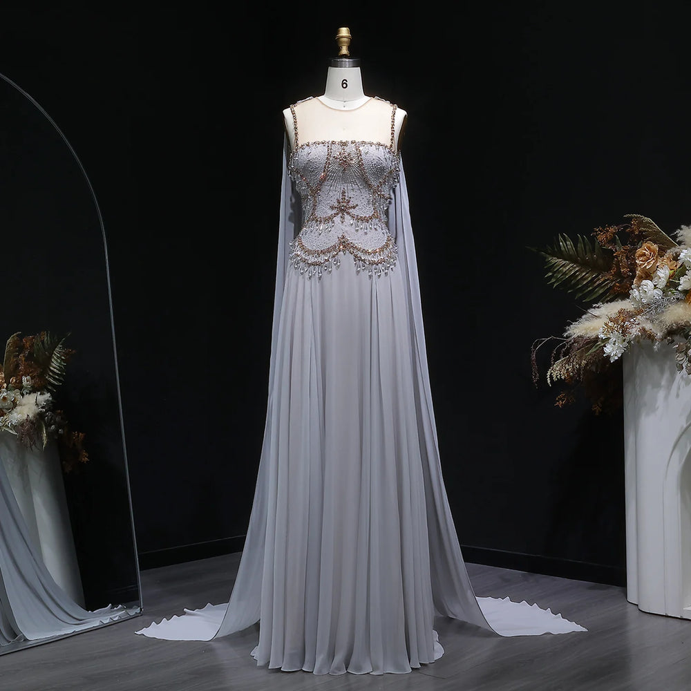 Silver floor-length tulle gown on mannequin with beaded bodice and cape sleeves