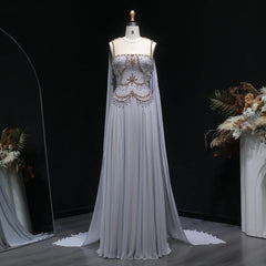 Silver floor-length tulle gown on mannequin with beaded bodice and cape sleeves
