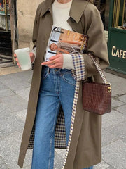 Single-breasted plaid coat layered for casual work and travel