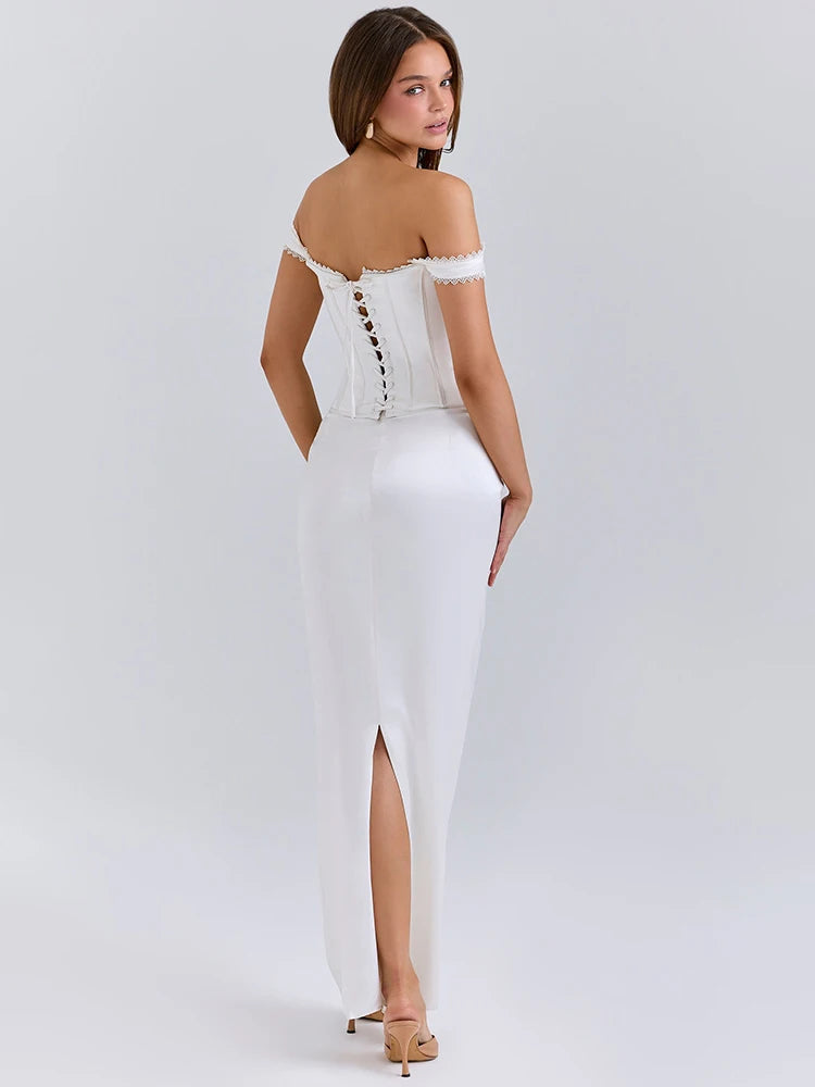 A woman wearing a sleek, satin backless dress featured in Pinterest style on a light grey back