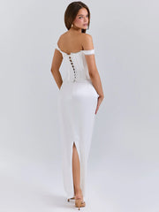 A woman wearing a sleek, satin backless dress featured in Pinterest style on a light grey back
