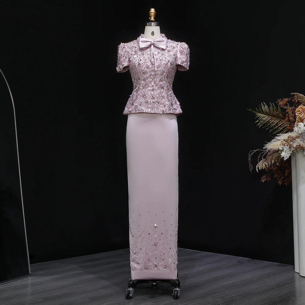 Full-length look focusing on the ivory floor-length skirt with a smooth, clean drape, styled with a fitted embellished top.