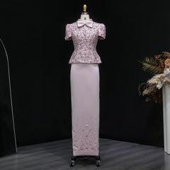 Full-length look focusing on the ivory floor-length skirt with a smooth, clean drape, styled with a fitted embellished top.