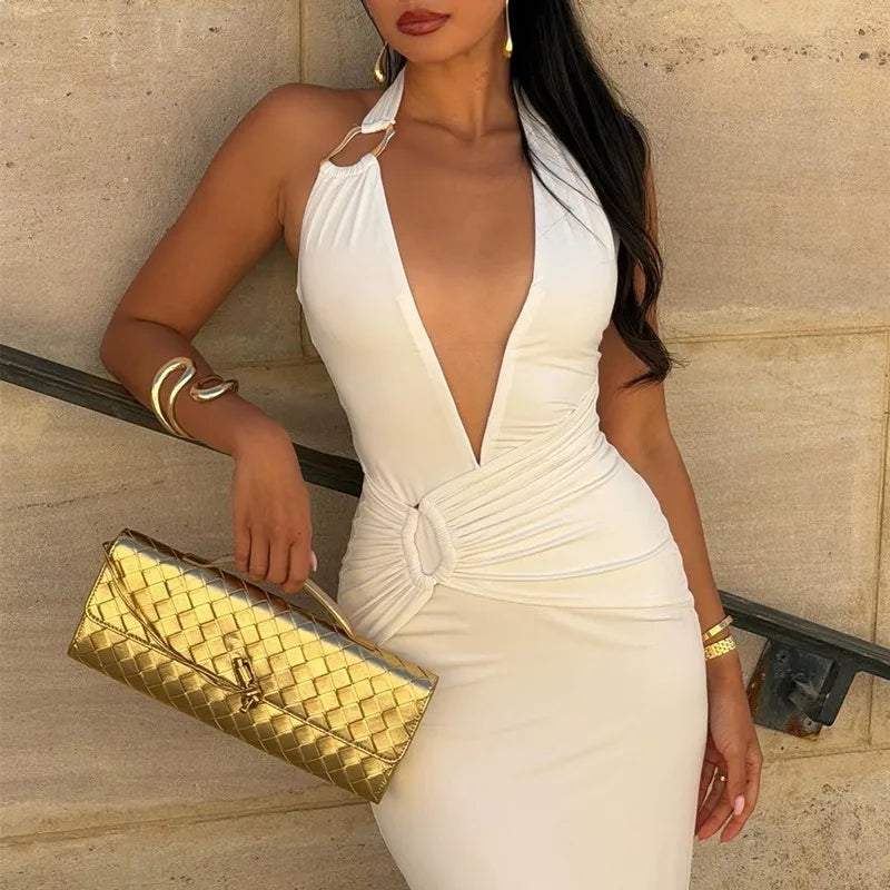 Backless long dress with deep V front styled against a neutral wall