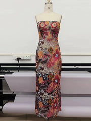 A sleeveless floral evening gown on a mannequin.