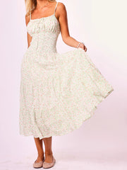 A sleeveless floral tiered dress styled casually with sandals.