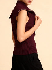 Close-up detail showing the zipper hardware and fine knit construction across the bodice