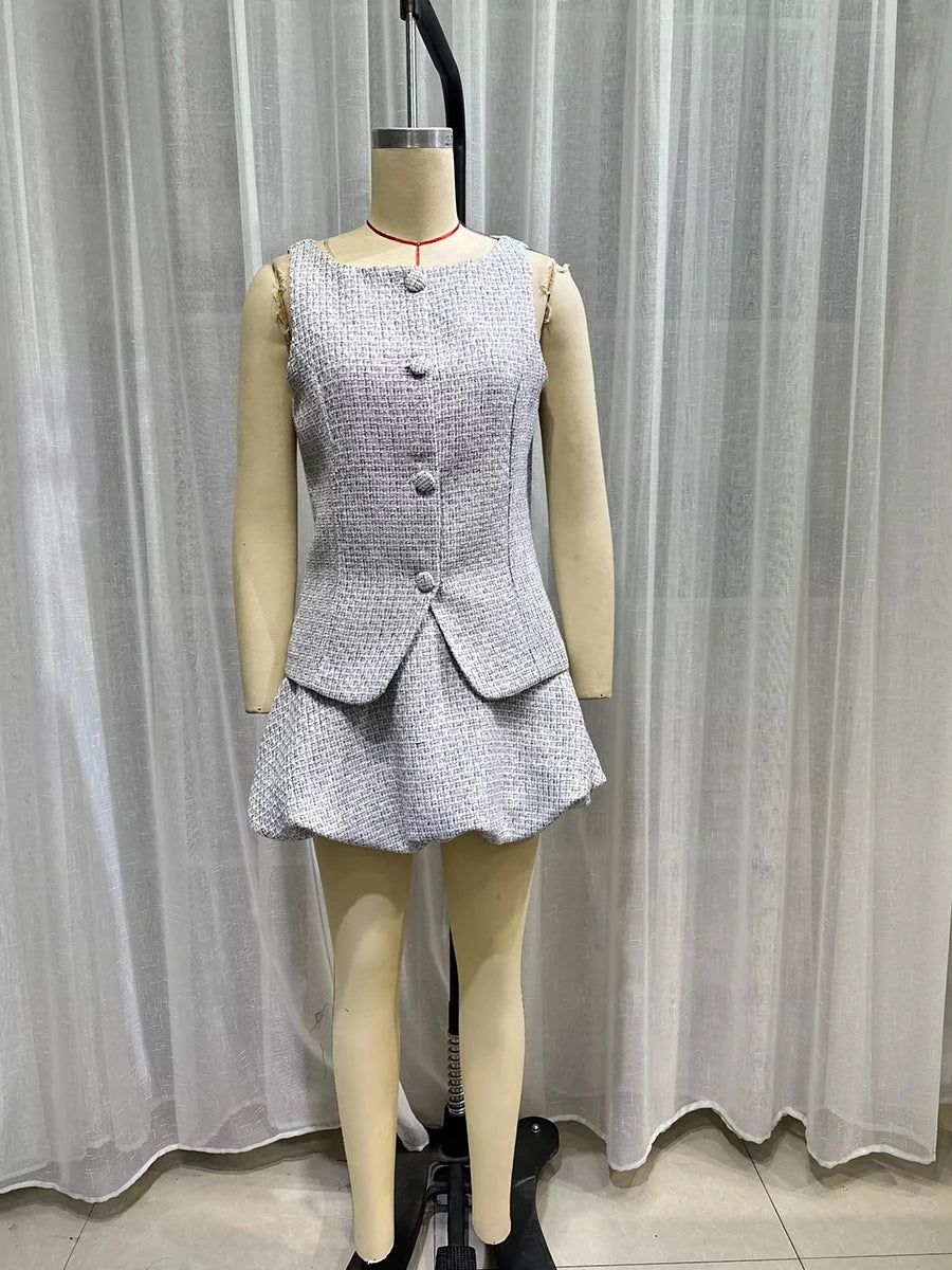 Grey sleeveless peplum outfit styled for office or business meetings