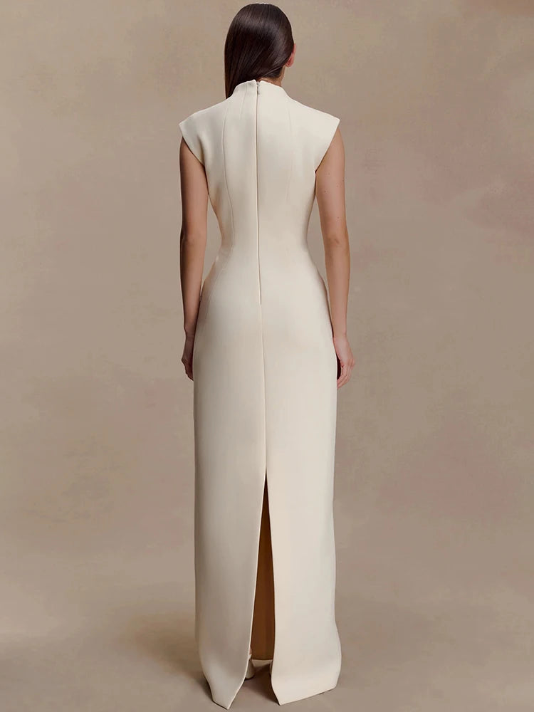 Straight-on angle emphasising the slim A-line shape and minimalist structure of the formal maxi dress.