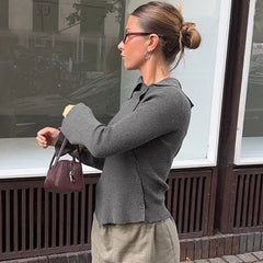 The slim silhouette of the knit top, highlighting its flattering fit.


