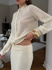 Side angle showing the slim silhouette and long sleeves of the knit top as it falls smoothly over the body.
