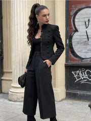 Outfit view highlighting the slim, waist-defining shape of a black mandarin collar blazer paired with wide-leg pants for a polished look.