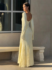 Side angle showing the flowing hemline and slim A-line shape of the maxi dress.
