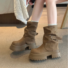 Close-up of brown slip-on ankle boots with thick sole