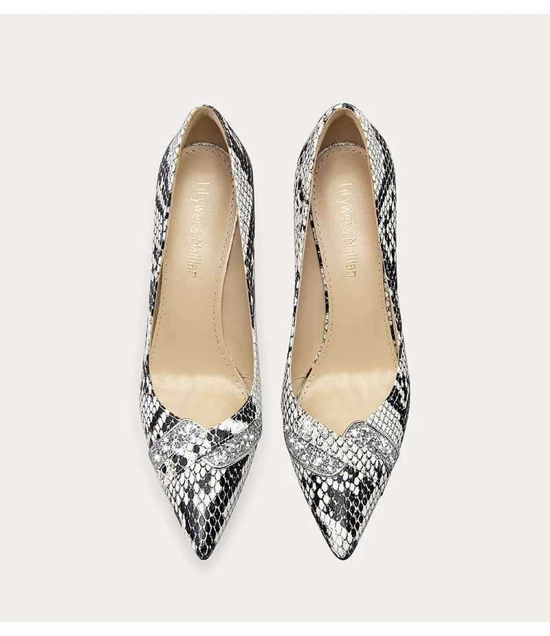 a snake print pump with a pointed toe and a thin heel.