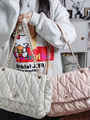 Large pink quilted handbag with secure zipper closure