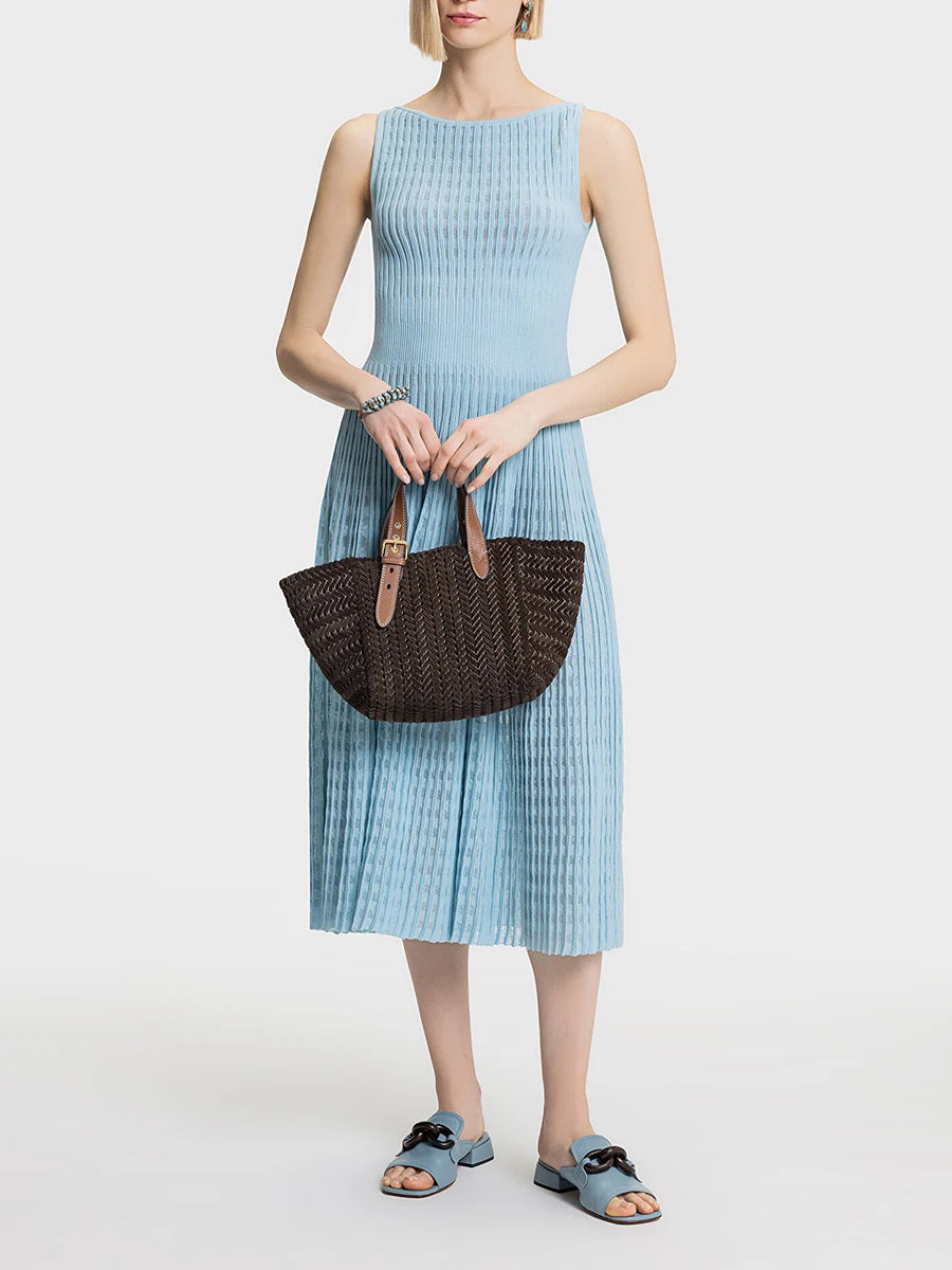 A woman modeling a solid A-line sleeveless midi dress with draped details.