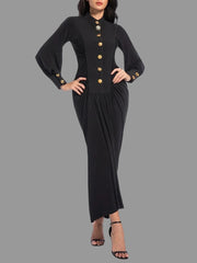 A woman modeling a solid ruched midi dress with a round neckline.