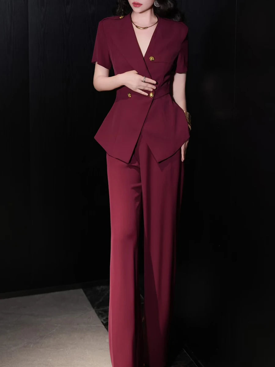 A woman modeling a solid two-piece set with a V-neck top and a pair of high-waist pants.