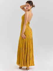 Woman wearing a yellow dress with floral patterns on a white background
