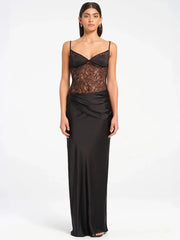 Woman wearing a spaghetti strap floor-length evening gown in sheer lace for club night on a white background