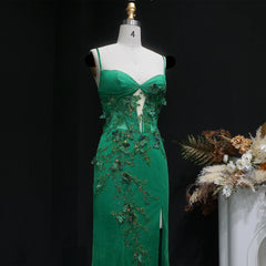 Backless formal gown with appliqué detailing and fitted waist