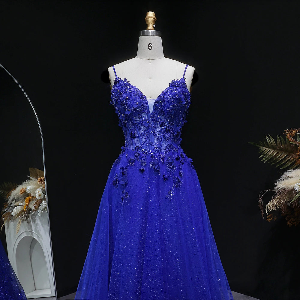 Floor-length A-line tulle gown with open-back detail and spaghetti straps