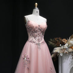 Floor-length A-line tulle gown with open-back detail and spaghetti straps