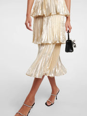 Close view of the pleated texture and rhinestone detailing on a champagne tiered midi dress.