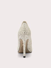 Close-up of shimmering gold sequin stiletto shoes
