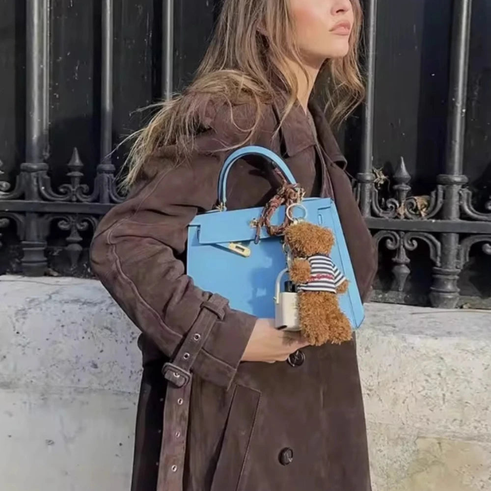 Model in layered autumn look with long grey trench coat