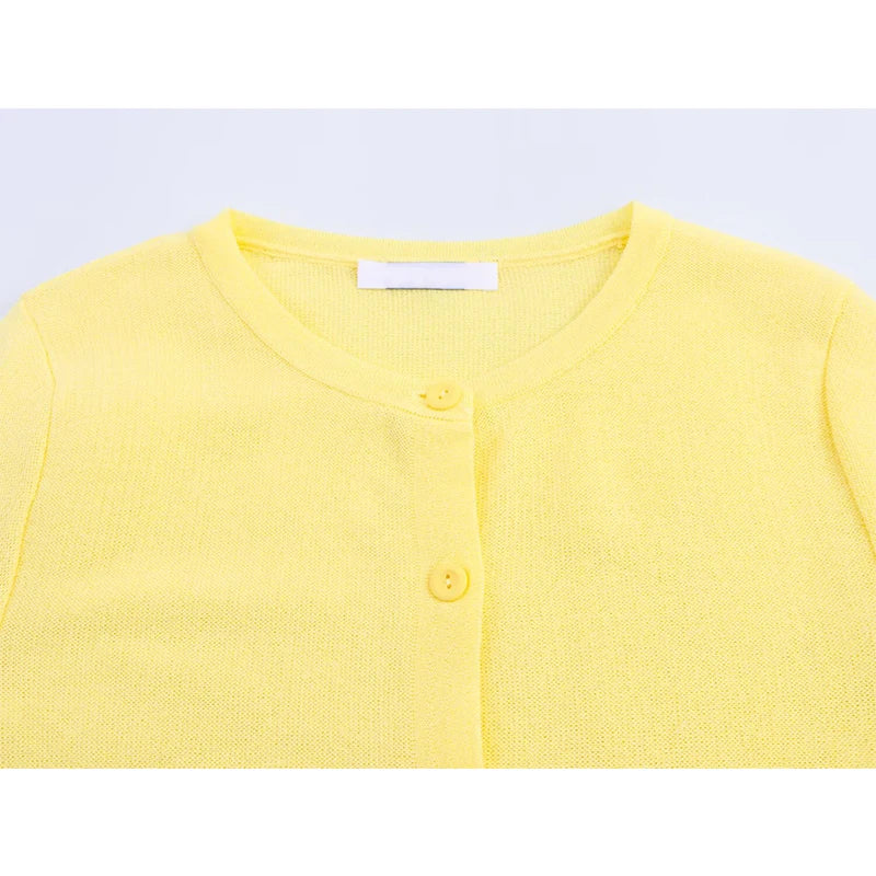 Feminine knitwear top in yellow with flattering waist flare