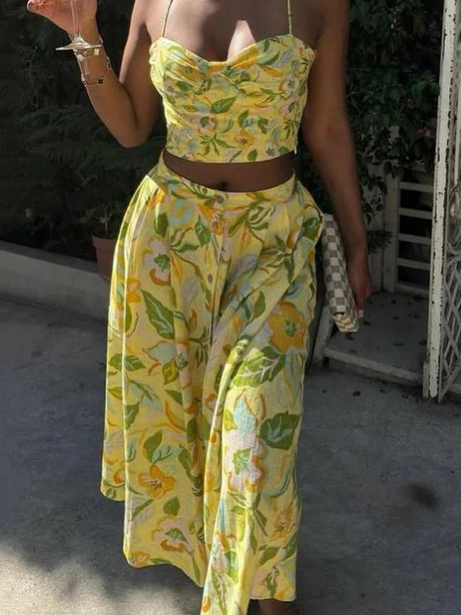 Person wearing a Square-neck crop top with matching high-waist floral skirt with a blurred background.