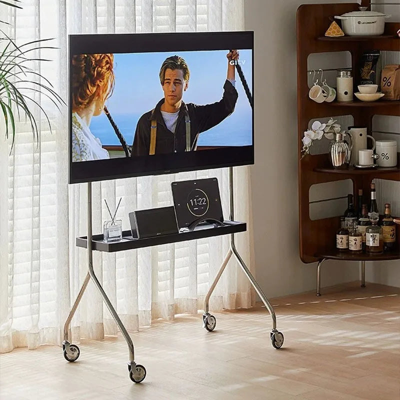Stainless steel rolling TV stand with shelf in a living room
