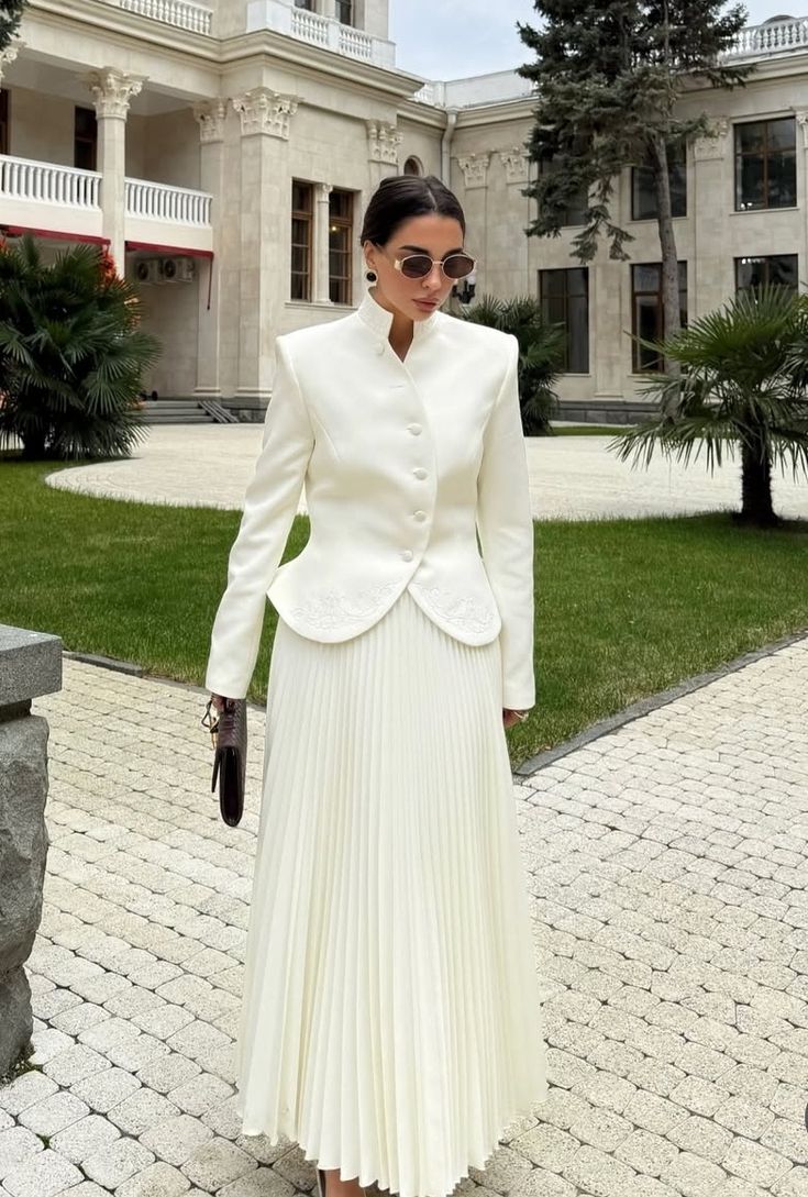 Close-up of the stand collar button top showing clean tailoring and smooth fabric finish.