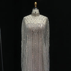 Statement beaded full sleeve formal gown styled for weddings and galas on a mannequin against a black background