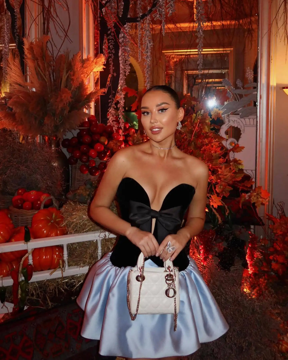 Statement bow strapless party mini dress shown on city background