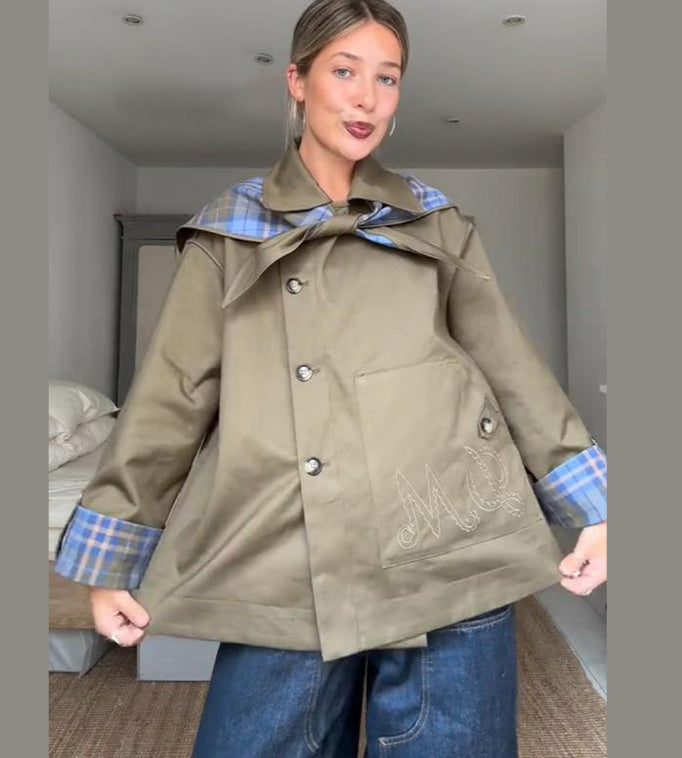 Statement checked jacket for women paired with mini skirt indoors