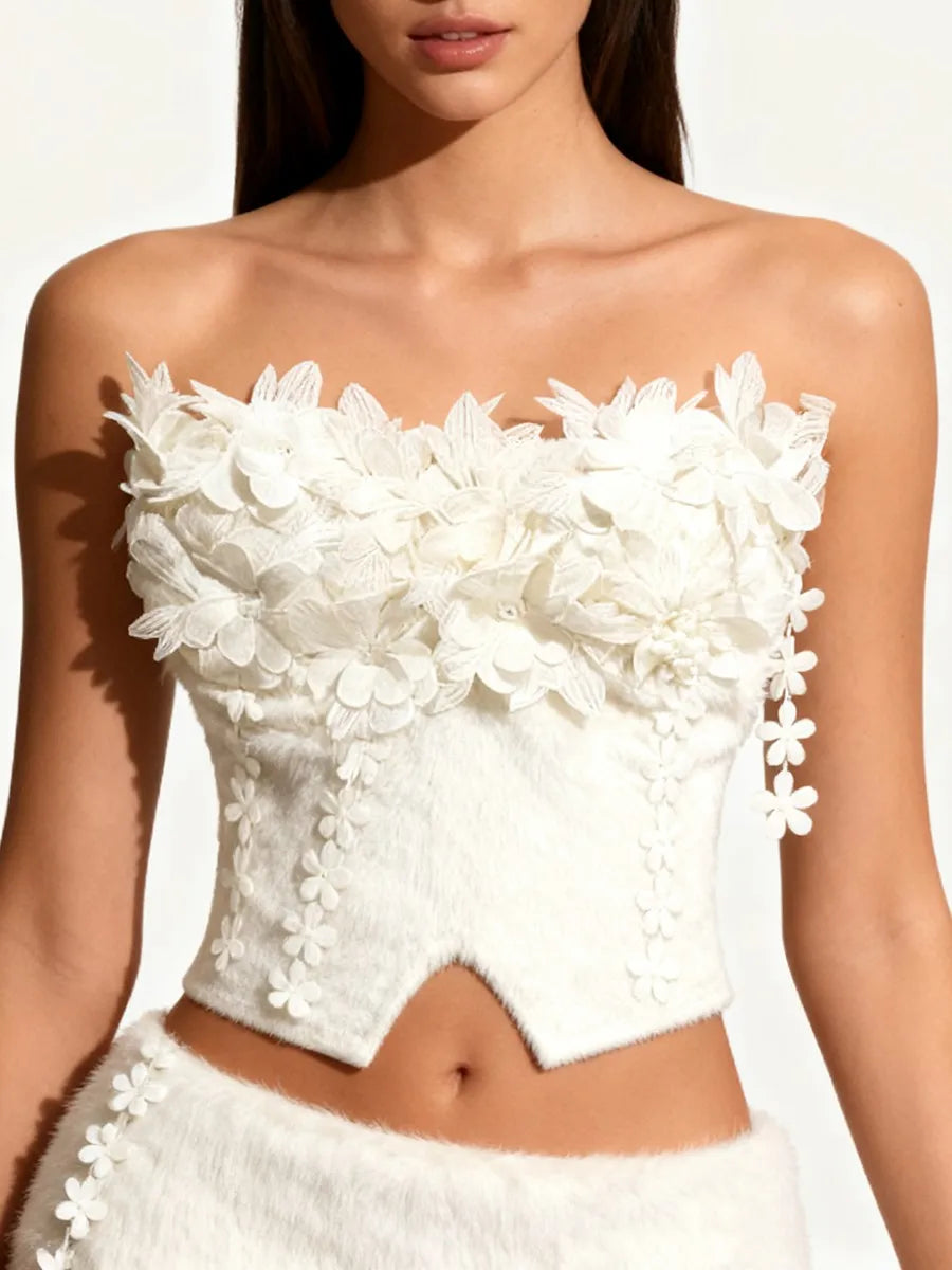 Model wearing a strapless corset-style top with raised floral detailing.