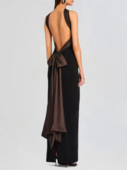 Strapless evening gown with flowing mesh bow and elegant back folds, captured against a clean background for formal styling.