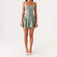A close-up of the strapless ruched top, showing the button details on the corset-style waist.
