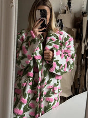 Three-quarter angle of a plush floral jacket paired with tights and boots, highlighting the roomy silhouette and everyday street styling.