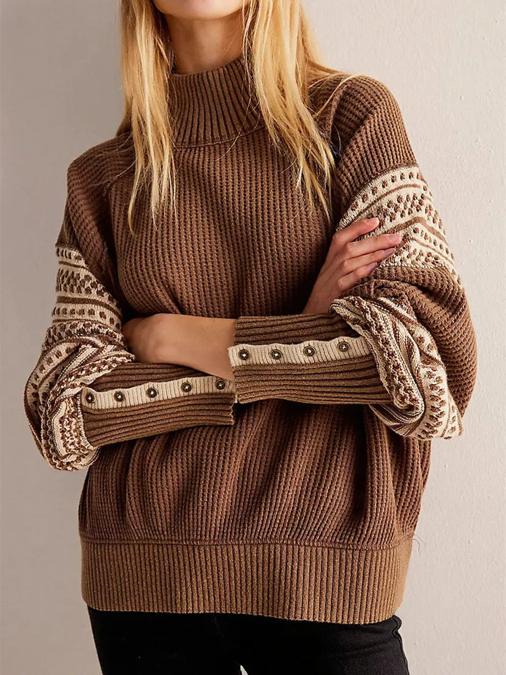 Close-up on the sweater’s sleeve showing crisp stripe pattern placement and textured knit finish with a clean, structured drape.