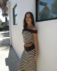 Side view of striped knit two-piece showing high-waist midi skirt