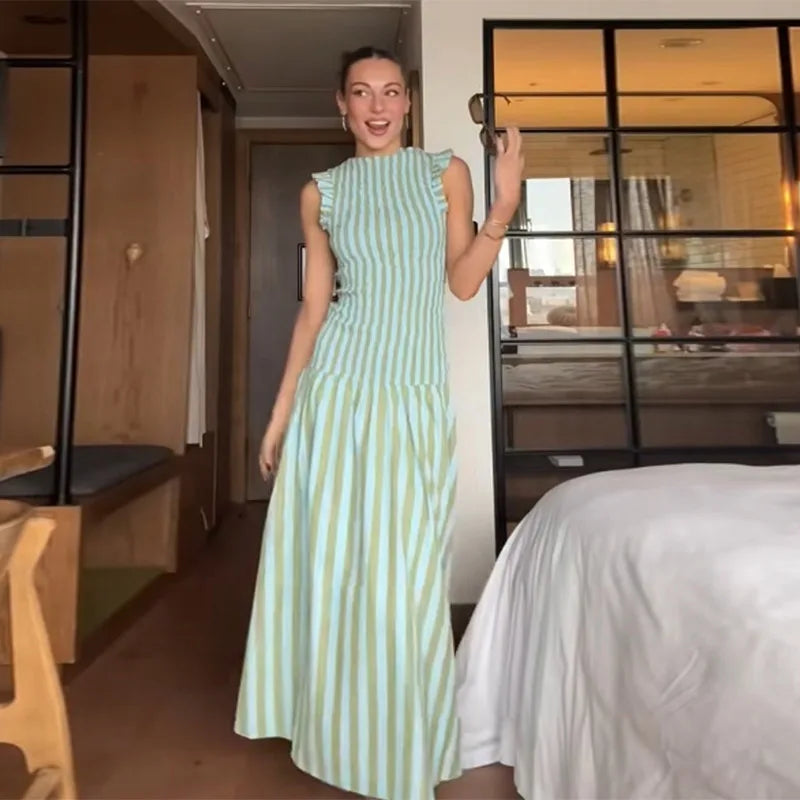 Woman wearing green and white striped pleated maxi dress for summer