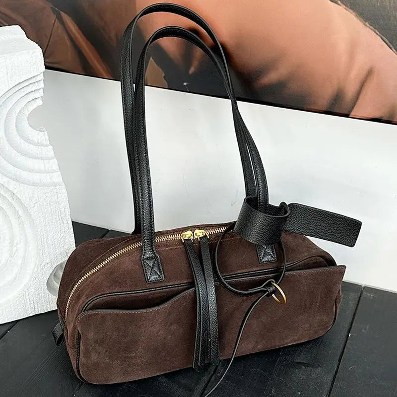 Deep brown box shoulder bag with long handles and gold-tone hardware accents