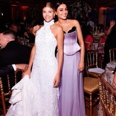 A woman wearing an elegant lilac satin corset evening dress.