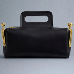 minimalist structured shoulder bag with clean edges and metallic accents