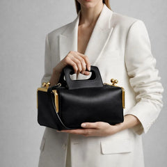 structured top handle shoulder bag with rectangular silhouette and hasp closure