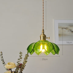 A pendant LED light fixture with a green  glass shade and a knob switch,  hanging with a painting on the  back ground with dimensions.